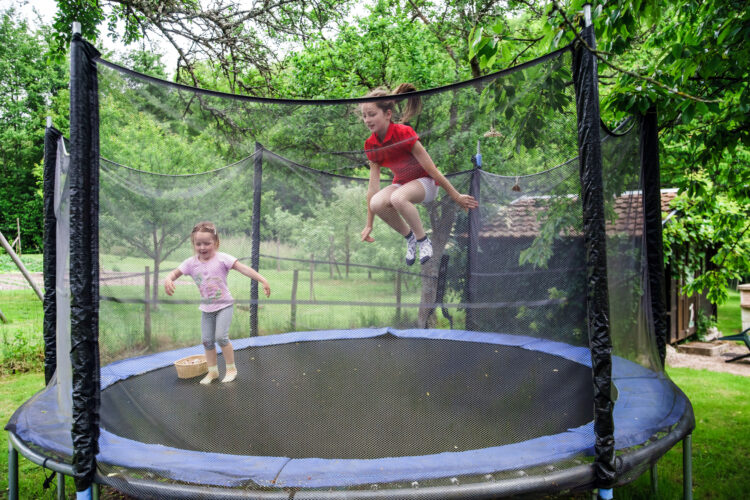Common Causes Of Child Injuries That May Result In Lawsuits - Two happy sisters on trampoline